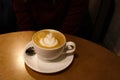 Coffee in a white cup on a wooden table