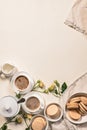 Coffee in white cups, delicious french macaroons. Dessert still life on a beige background. Vertical shot. Copy space Royalty Free Stock Photo