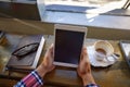 Coffee and wireless freedom. a man using a digital tablet at a cafe. Royalty Free Stock Photo