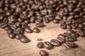 Coffee on wooden background. Brown roasted coffee beans, seed on dark background. Espresso dark, aroma, black caffeine drink.