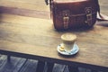 Coffee on wooden table with leather Bag Hipster lifestyle outdoor