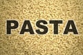 Pasta written with macaronis as background Royalty Free Stock Photo