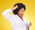 Coffee, yawning and tired black woman in studio, waking up in the morning or sleepy isolated on a yellow background Royalty Free Stock Photo