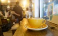 Coffee in yellow coffee cup and on a wood background Royalty Free Stock Photo