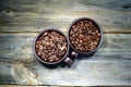 Coffeebeans in ceramic coffee cups Royalty Free Stock Photo