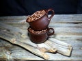 Coffeebeans in some ceramic coffee cups on a wooden table Royalty Free Stock Photo