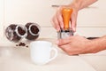 Coffeemaker tamp ground coffee with tamper on table Royalty Free Stock Photo