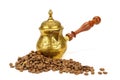 Coffeepot and coffee beans on white background