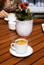 Coffees on table with plant and woman