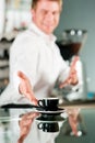 Coffeeshop - barista presents coffee Royalty Free Stock Photo