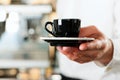 Coffeeshop - barista presents coffee or cappuccino Royalty Free Stock Photo