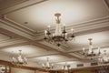 Coffered ceiling with classic crystal chandeliers in the interior.