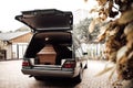 wooden coffin in the back of a car at the crematory