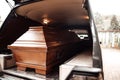 coffin in the back of a car at a funeral