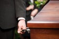 Coffin bearer carrying casket at funeral