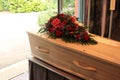 A coffin with a flower arrangement in a morgue