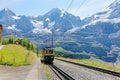 A cog wheel train traveling on the mountain Railway from Wengen to Kleine Scheidegg station Royalty Free Stock Photo