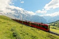 A cog wheel train travels on famous Jungfrau Railway from Kleine Scheidegg to Jungfraujoch station