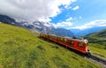 A cog-wheel train travels on famous Jungfrau Railway from Kleine Scheidegg to Jungfraujoch station ( top of Europe ) Royalty Free Stock Photo