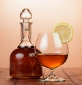 Cognac in bottle and glass with lemon Royalty Free Stock Photo