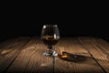 Cognac or brandy in a glass on a rustic background. Chocolate on the table. Selective focus Royalty Free Stock Photo