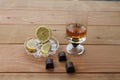 Cognac Brandy lemon slices Brandy goblet of scotch whiskey Chocolate lemon on a wooden background with