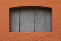 Cognac-colored stone wall with blue wooden door. Royalty Free Stock Photo