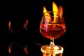 Cognac glass with the burning fire flames Royalty Free Stock Photo