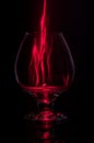 Cognac glass with fire.Fiery glass on a black background