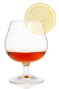 Cognac glass with lemon on white Royalty Free Stock Photo