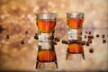 Cognac or liqueur, coffee beans and spices on a glass table. Royalty Free Stock Photo