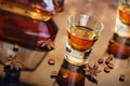 Cognac or liqueur, coffee beans and spices on a glass table. Royalty Free Stock Photo