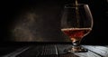 Cognac is poured into a glass. On dark background. 4k.