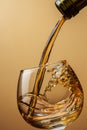 Cognac pouring from bottle into glass Royalty Free Stock Photo