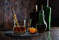 Cognac with a slice of citrus and spices. Drink in a glass and a variety of bottles. Bar counter and drinks. Royalty Free Stock Photo