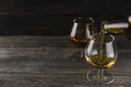 Cognac in two glasses on a dark wooden background Royalty Free Stock Photo