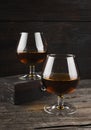 Cognac in two glasses on a dark wooden background Royalty Free Stock Photo