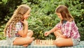 Cognitive development. Intellectual game. Make decision. Smart children. Children play chess outdoors nature background