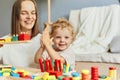 Cognitive development puzzles. Montessori learning approach. Fun family activities. teacher or mother playing with baby with