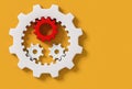 Small red and white connecting gear cogs inside big white cog isolated on yellow background, 3d render, 3d illustration Royalty Free Stock Photo