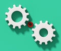 Small red cog between two big white cogs isolated on green background, 3d rendering Royalty Free Stock Photo