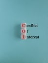 COI, Conflict of interest symbol. Wooden cubes with concept red words \'COI