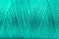 A coil of aqua thread. Spool of colored threads on a white background. Waxed sewing thread for leather crafts. Royalty Free Stock Photo