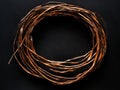 A coil of copper wire on a black surface Royalty Free Stock Photo