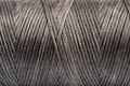 A coil of gray thread. Spool of colored threads on a white background. Waxed sewing thread for leather crafts. Royalty Free Stock Photo