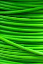 A coil of green electrical cable close-up