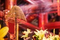 Coil of incense burning with white smoke in Buddhist temple background Royalty Free Stock Photo