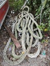 a coil of old nylon rope laying beside the wooden boat. Royalty Free Stock Photo