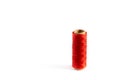 A coil of red thread. Spool of colored threads on a white background. Waxed sewing thread for leather crafts.