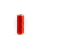 A coil of red thread. Spool of colored threads on a white background. Waxed sewing thread for leather crafts.